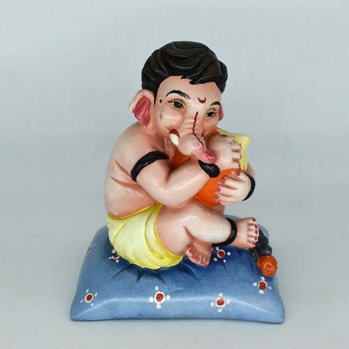 Bal Ganesha Sitting On Pillow With Modak Idol For Home Decor