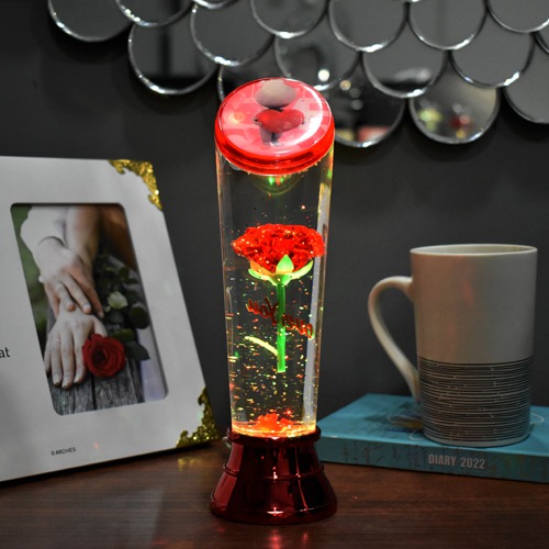 Beauty and the beast eternal rose flower floating in a snow glass bottle with multicolored LED lighting for this Valentines Day