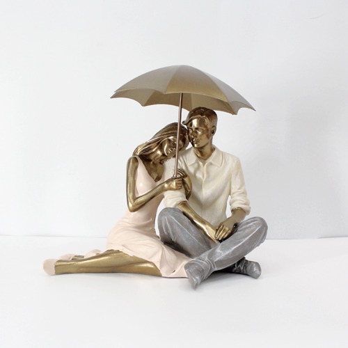 Romantic Couple Sitting Together And Holding Umbrella Statue Showpiece