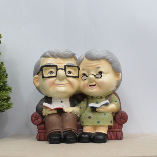 Cute Old Couple with Piggy Bank