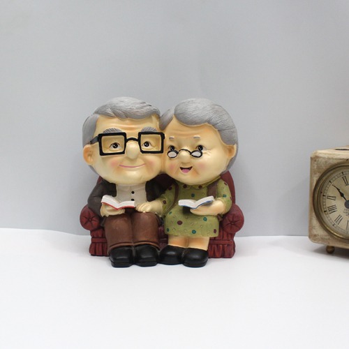 Cute Old Couple with Piggy Bank