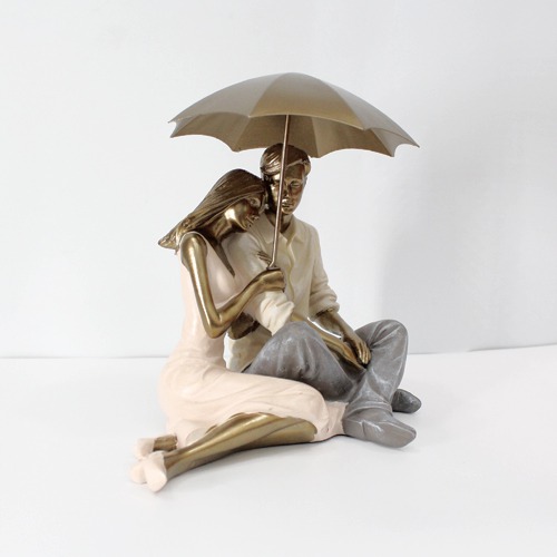 Romantic Couple Sitting Together And Holding Umbrella Statue Showpiece