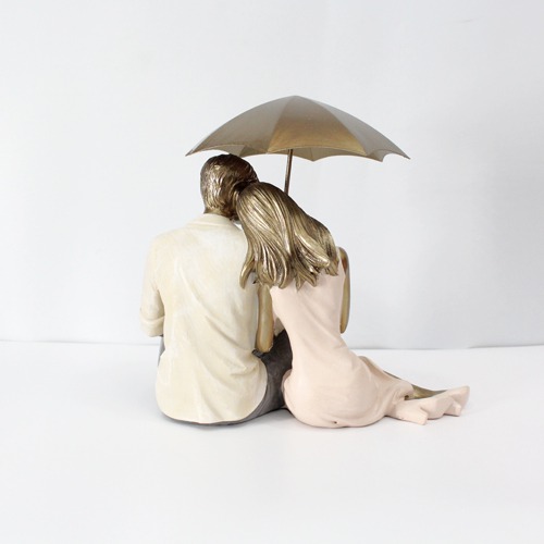 Romantic Couple Sitting Together And Holding Umbrella Statue Showpiece