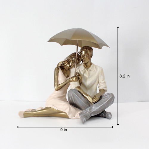 Romantic Couple Sitting Together And Holding Umbrella Statue Showpiece